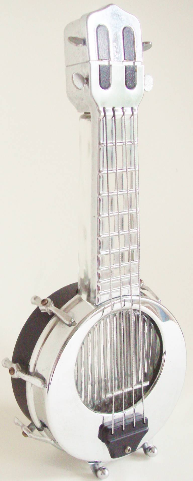 This fabulous Japanese export Mid-Century Modern chrome and black enamel  banjo figural decanter plays a heart warming version of the tune 
