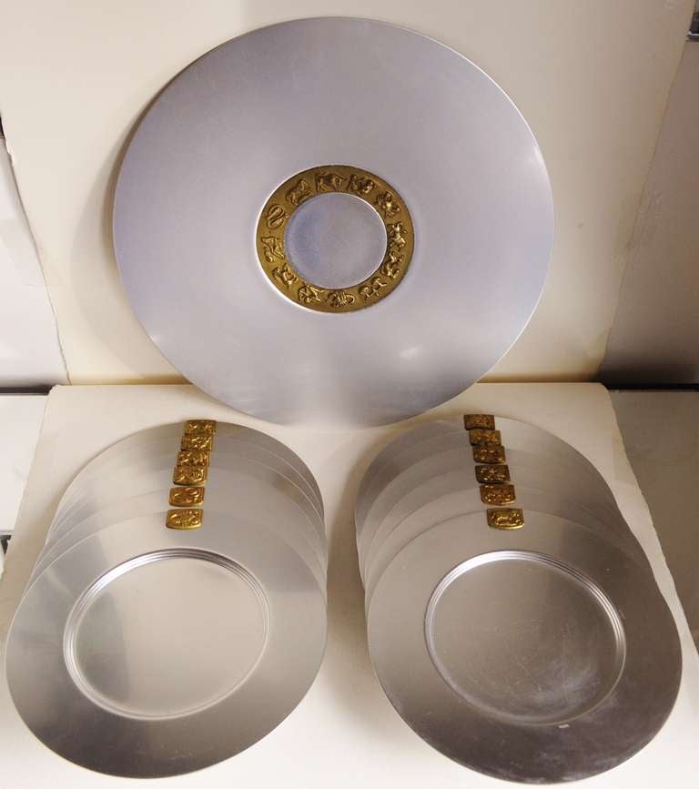 This rare complete set of the iconic brushed aluminium 'Zodiac Service Plates' (11