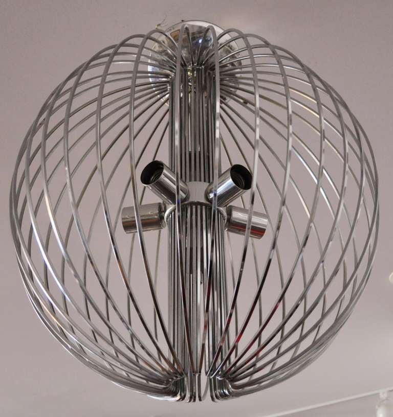 This large spherical cage chandelier features five-bulb sockets and its original ceiling cap. We have had other variations of Gaetano Sciolari iconic cage lamps for Lightolier before but this is the only large spherical example that we have come