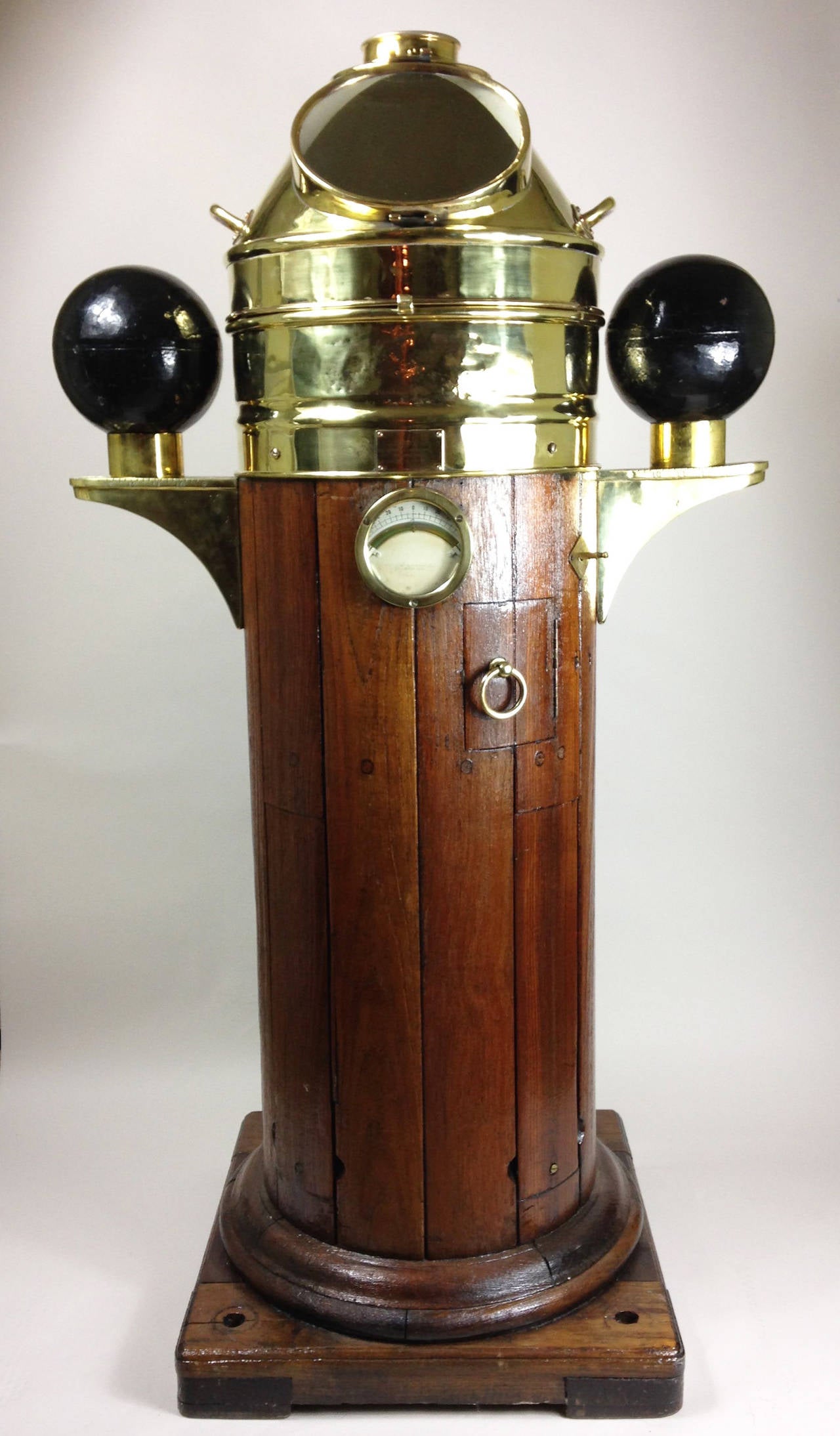 A wonderfully restored early 20th century teak and brass ship's binnacle.

Complete with spirit level and polarity spheres. Applied brass plate to the front with makers mark of Lilley and Reynolds Ltd, Nautical Instrument Manufacturers,
