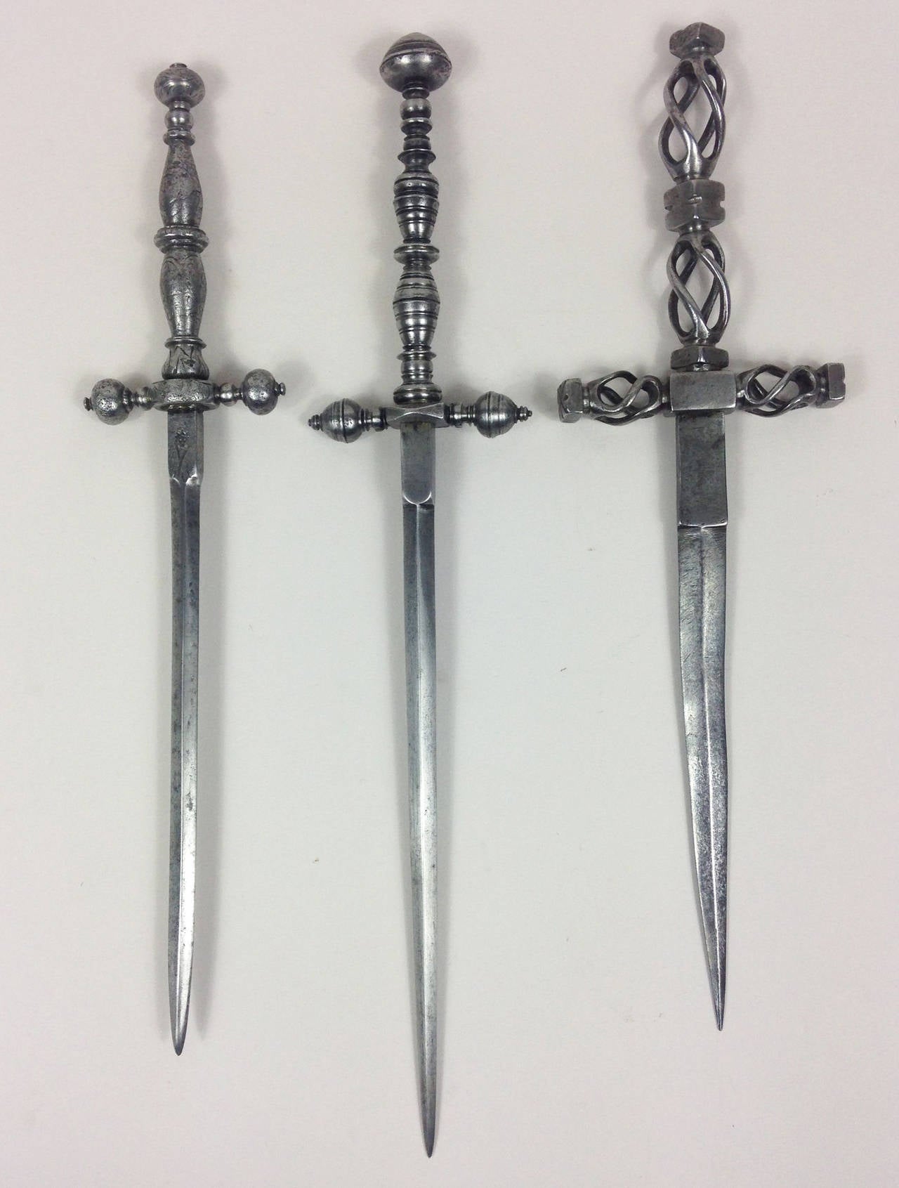 A fine group of three all-steel Italian daggers.

Each one different, varying in periods and hilt designs but of traditional form. The latest being circa 1850.

Measuring (left to right): 26, 29.5 and 26 cm. Sizes stated below are for the
