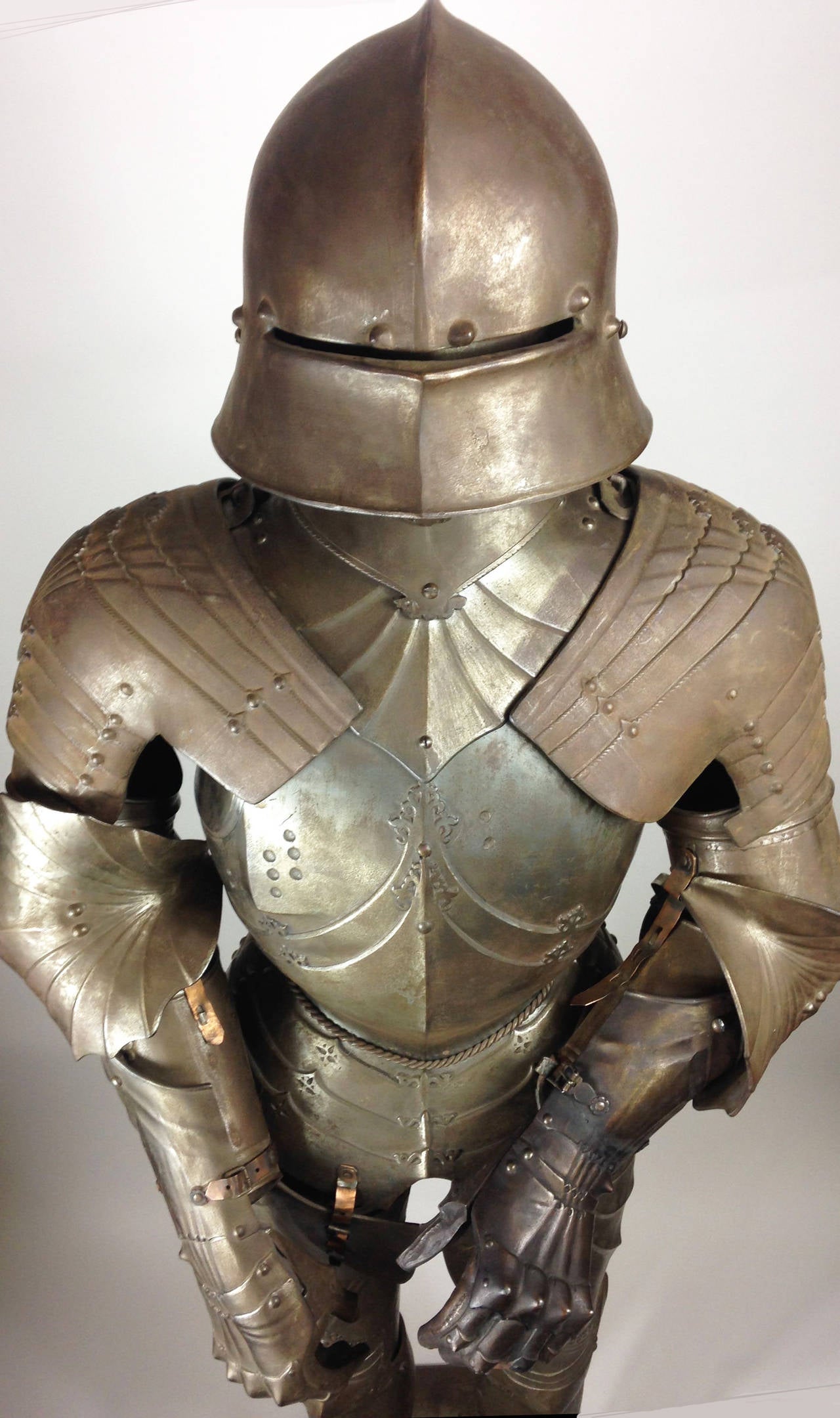 A finely made full-size cast iron armour in the Gothic style.

Most probably dating from the late 19th century, with fixed torso, legs and base, with additional separate elements such as the helmet, arms, gauntlets etc. 

An extremely heavy item