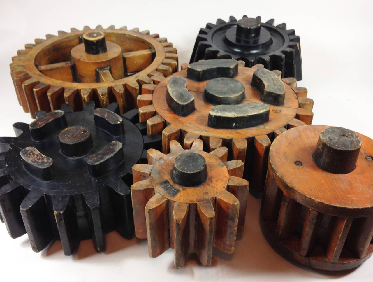 A decorative group of wooden cog moulds.

Each example is different and all but one originates from the Honeybourne Brick Company, England. 

Wonderful items which would make a unique wall feature. The largest measures 45 cm across with the