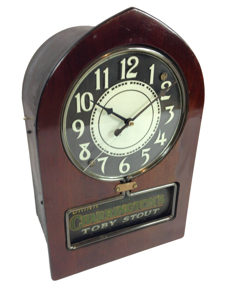 A wonderful example of an early 20th century electric ad clock by Telechron.

Known as the 'Cathedral' style, this clock has 6 rotating adverts on black paper  under the clock face. These rotate every 10 seconds and are all present and