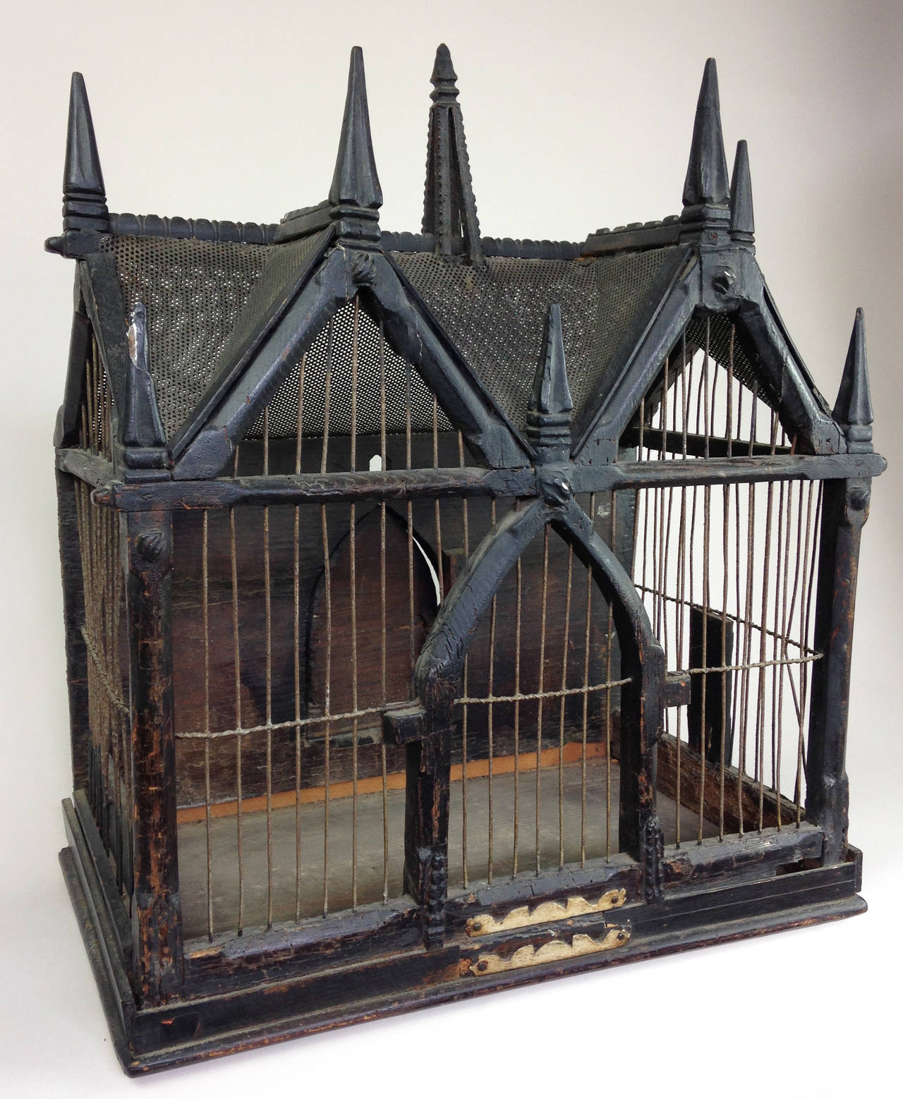 A wonderfully Gothic song bird cage of wood and metal. 

Beautifully made and dating from the mid-late 19th century. Some wear and minor loss but this only adds to the charm.