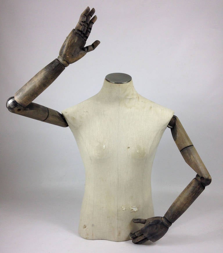 A wonderful vintage male mannequin constructed of a fabric covered heavy-duty plastic torso. 

The arms are of stained wood and are fully articulated with moveable joints from the shoulders to the knuckles. Missing little finger from the left hand