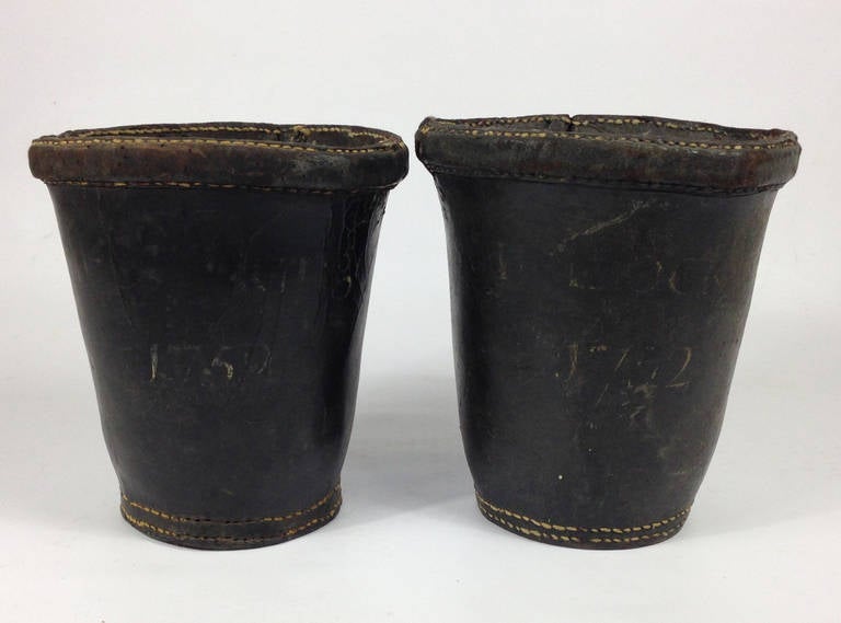 A very rare pair of 18th century English leather fire buckets. 

Wonderful condition. Each hand-painted with the date of 1752. Above the date appears to be the remains of the name 'West Lockinge' which is a village within Oxfordshire, England.