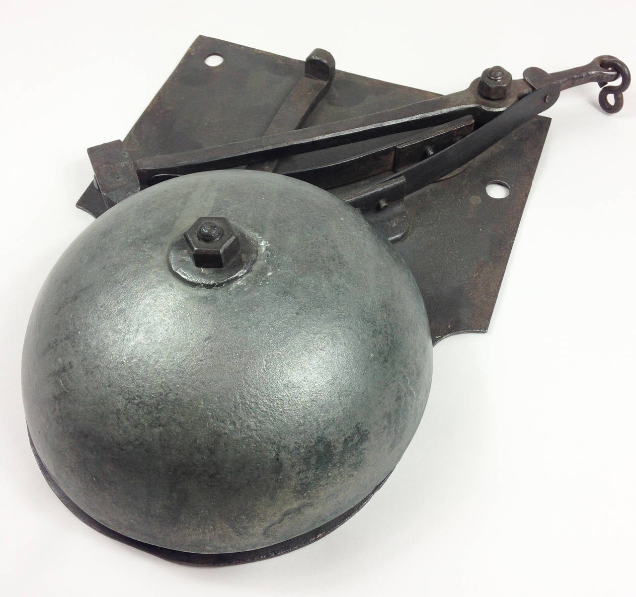 A wonderful iron bell which originated from a convent in Northern France. 

Operated by simply attaching a cord or chain to the end of the swing arm. Still works very well with a lovely loud ring.

France, early 20th century.