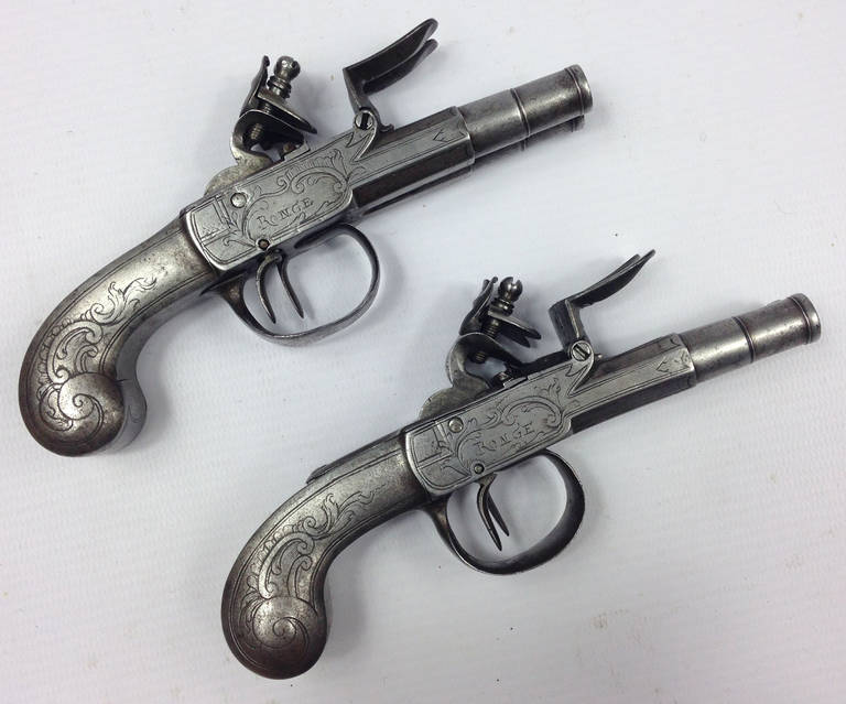 A fine pair of all metal double barrelled flintlock pistols in the style of Segalas of London.

Each signed RONGE to one side and LAEN W to the other. Good working actions with sliding trigger guard safety mechanisms and 2 inch cannon