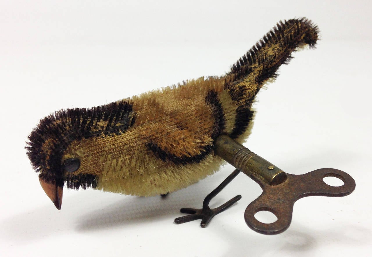 A wonderful little clockwork pecking bird by the much sought after firm Schuco.

Comes with its original key and it still frantically pecks away when wound. Some loss and dulling to the fabric finish.