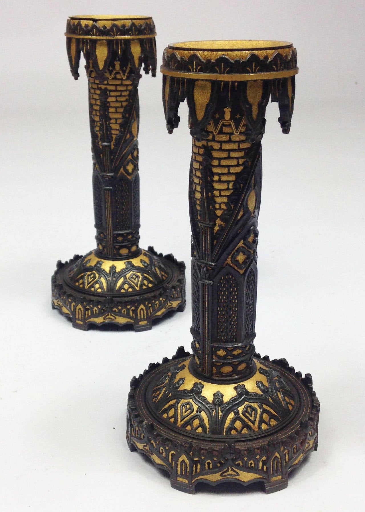 A scarce pair of Spanish 19th century chiseled blue steel and gilt candlesticks.

Elaborate Gothic tracery and block work designs. Each signed on the base Teodoro Ybarzabal Eibar.

Width measurements are taken across the base.