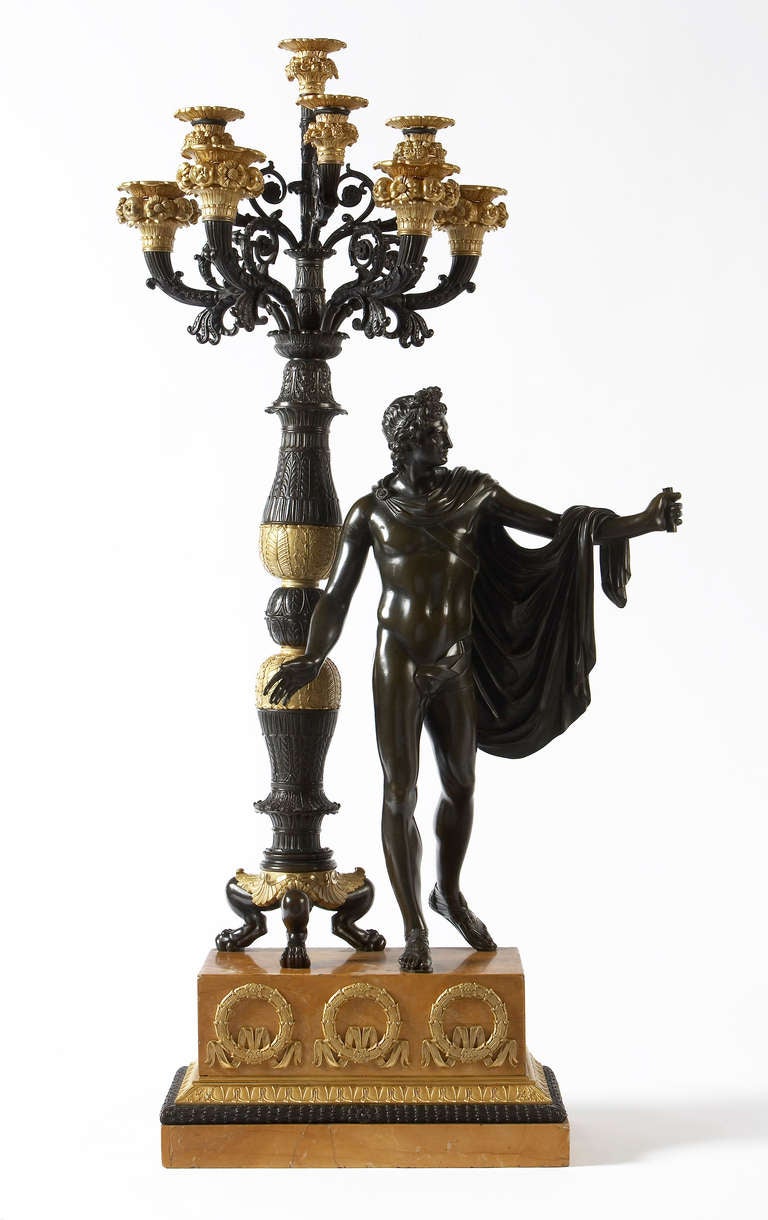 A large pair of bronze and gilt bronze candelabra of Apollo and Diana; each with eight scrolled candle arms surmounted by fruit and flower nozzles; on a rectangular square Sienna marble base: French, circa 1820.
Provenance: Formerly in the