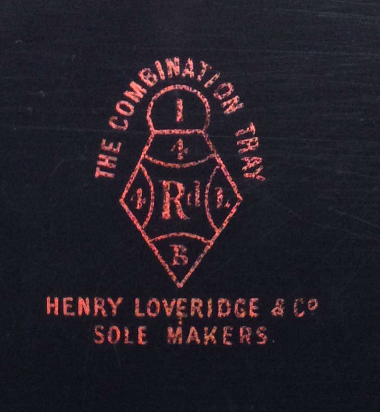 A fine small red lacquer tray table with the original gallery, on a later gilt metal stand, the underside stamped 'THE COMBINATION TRAY - HENRY LOVERIDGE & CO - SOLE MAKERs': English, circa 1880.