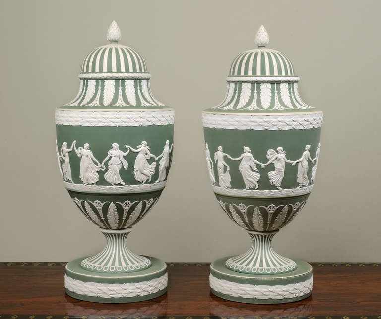 Each Vase is decorated with one of the best-known of all the Wedgwood reliefs, the Dancing Hours, which are attributed to John Flaxman, the finials are in the form of artichokes, the bases are applied with laurel bands
Provenance: Viscount Cowdray