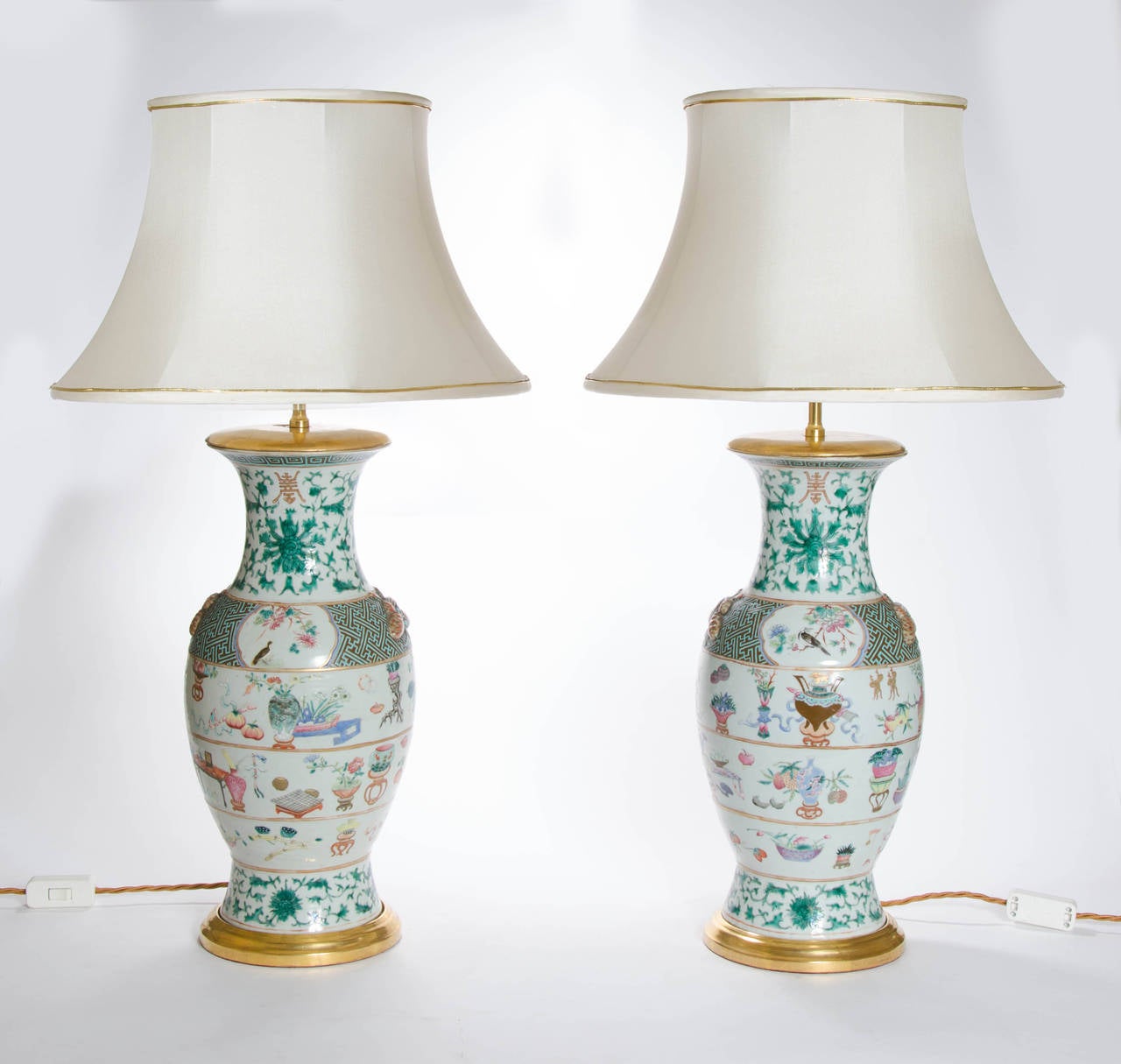 A fine pair of baluster vases as lamps, decorated with an array of symbolic objects, flowers, butterflies and lotus scrolls:
Chinese, Camille-rose, circa 1840. 

Height including shade: 87 cm.