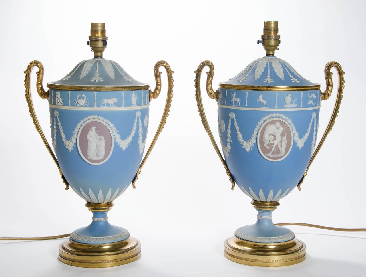 A splendid Pair of 19th century Wedgwood jasper ware Lamps decorated with the symbols of the zodiac, classical medallions and swags 
Dimensions of lamp without shades: Height 35 cm; Width: 37 cm