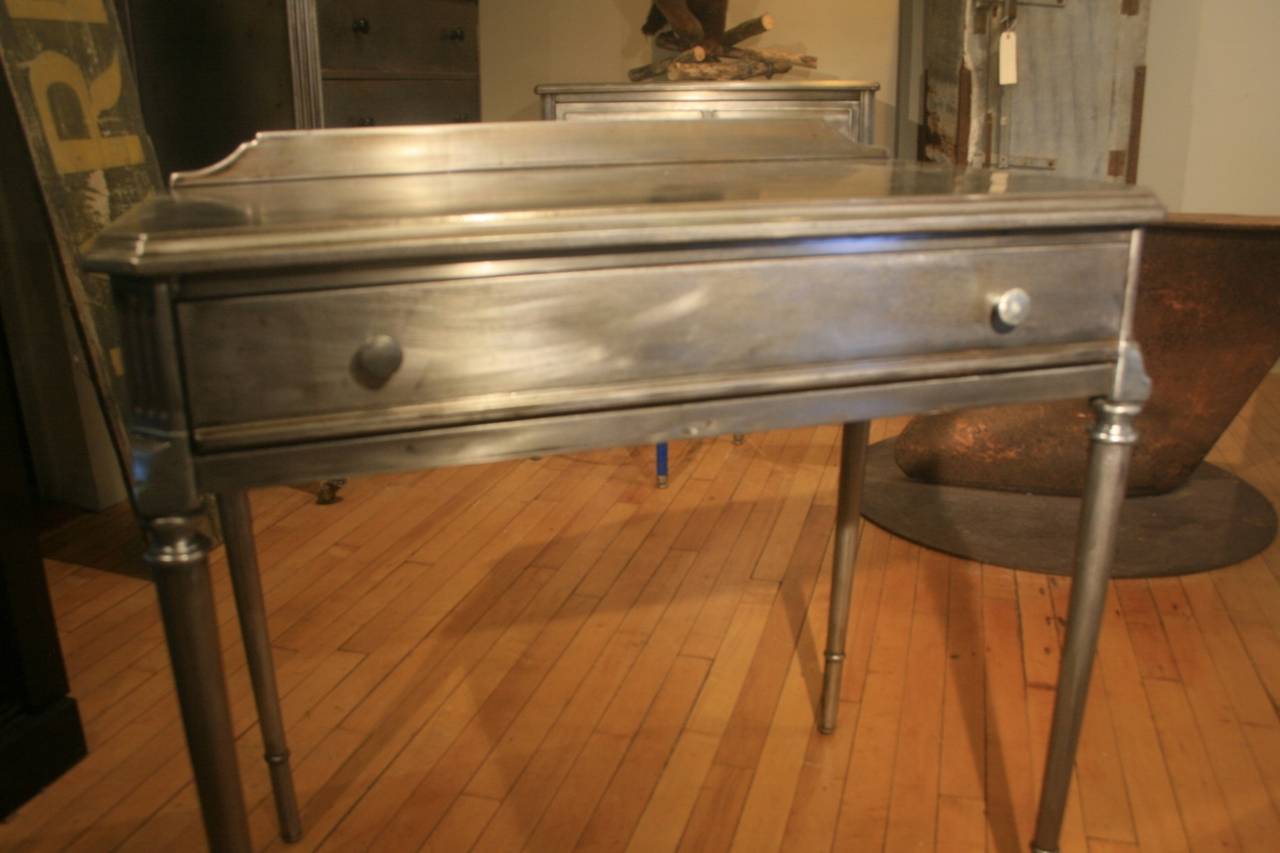 Great Industrial Looking Steel Desk made by the Simmons Co. in the 1930's. The desk has been stripped of it's original paint  down to the bare steel and coated with a clear coat of poly-urethane to prevent rust.  There is some slight pitting from