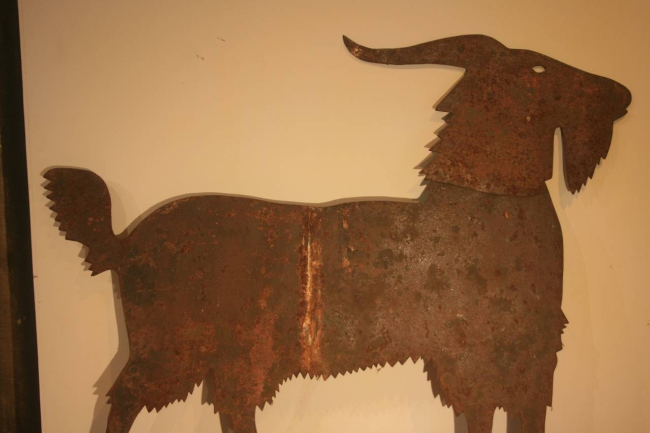 This is a great 19th century folk art goat weathervane.  Original red paint survives mixed with rust for an interesting effect.  The cut out metal shape is what makes this a superior piece of folk art.  This was a totally invented design, and a one
