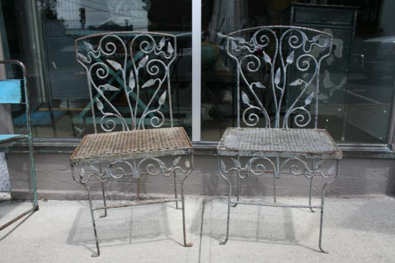 Beautiful, Homemade, Folk Art Garden Chairs. These chairs are strong enough to stand alone as sculptures The leaf pattern was all hand made and really makes the chairs.  The seats are a kind of industrial mesh, but they set off the leaves. Gray