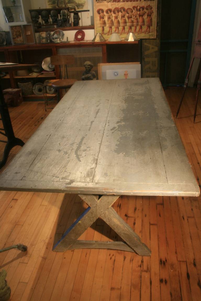 Painted American Sawbuck Table. Silver! Amazing! How many old American wooden tables have you seen painted silver. Exactly. The table came from an old mill building in Pawtucket, Rhode Island, where an industrial company was painted metal parts