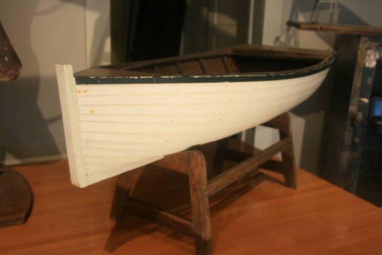 Beautiful large wood boat model. I believe this is an accurate wooden model of a sailboat or a rowboat. Painted white and on a nice stand.
