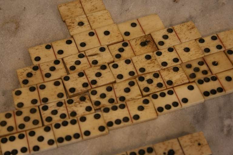 Set of Whalebone Dominoes.  Probably made by a sailor on a whaling ship in the 1800's.  One piece missing the blank 5 but two extra pieces could fill in.  Their look rather than their use what's important.
