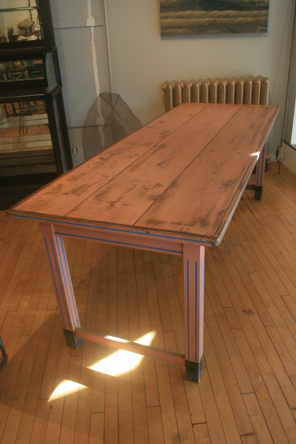 Beautiful salmon pink European farm table. The legs, apron and edge all have fluting painted blue for a nice accent. The paint is all original. The table has very nice proportions and great color.