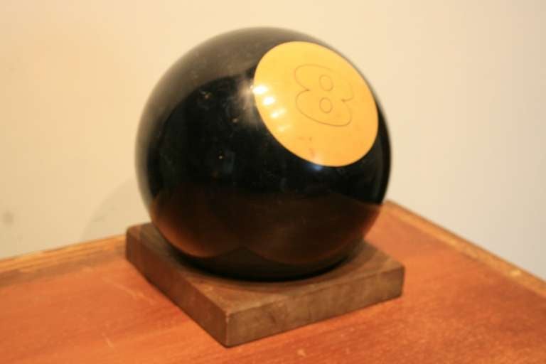I love oversize things.  This is an 8 Ball made from a bowling ball  
that was never drilled for holes.  Probably a promotional tool to sell pool tables.  Has a nice wood base it fits in snugly.  
A funny piece.