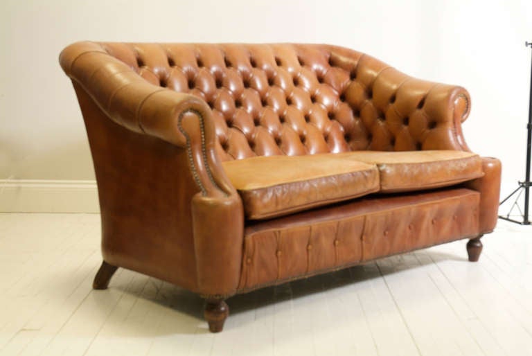 A very interesting and rare Chesterfield sofa with two Quallofil cushions and a high back. The sofa has beautifully elegant swan neck arms and a dainty personality offered by its petite frame. Don't be deceived, though. This piece is extremely well
