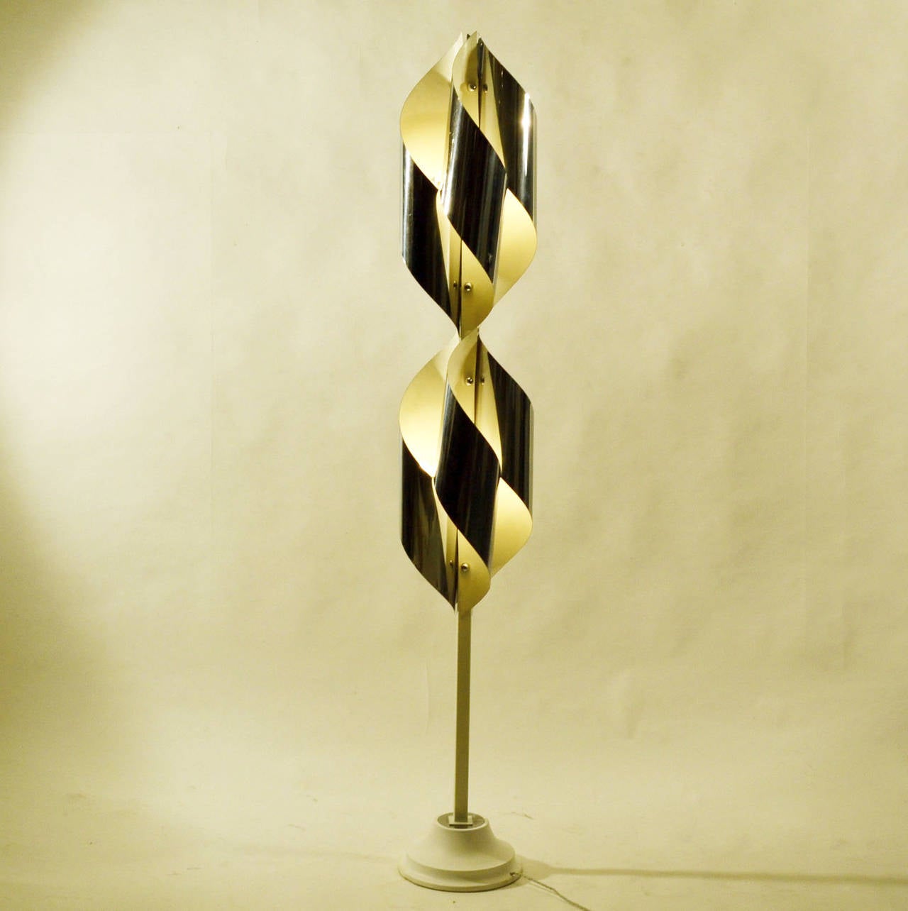 Twisted chromed sheet metal shaped in an array around the center stem. The lamp has eight lights.