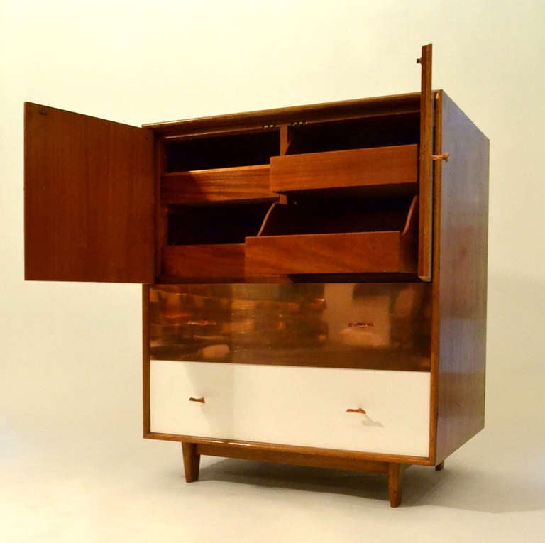 Quality wooden cabinet with Formica top and front drawer and doors and one-drawer front in copper. The side panels are made of Palisander. The pull bamboo shaped handles are cast in copper. The interiors are made of mahogany.
?The unusual deep