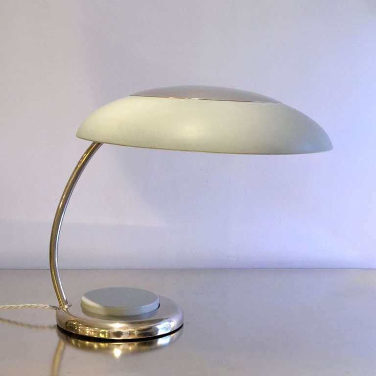 Light grey and nickel-plated desk lamp with an oversized on/off button incorporated in the base in the style of the Bauhaus Kaiser lamps.
There is a pair of grey lamps and one single red lamp available.
