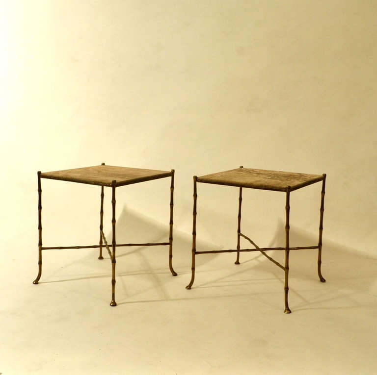 Pair of French side tables cast in bronze in faux bamboo.
The top is in a chocolate brown and sandstone marbled leather.
