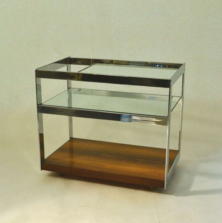 This minimalist trolley is made from chromed steel, glass and beautifully figured Rio rosewood veneers.Designed and manufactured in the 1960's by the British company Merrow Associates,
