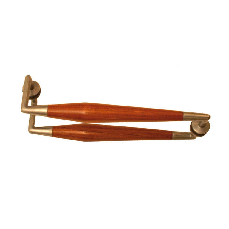 The door handles are cone shaped carved in walnut the attached ends are cast brass and nickel plated.