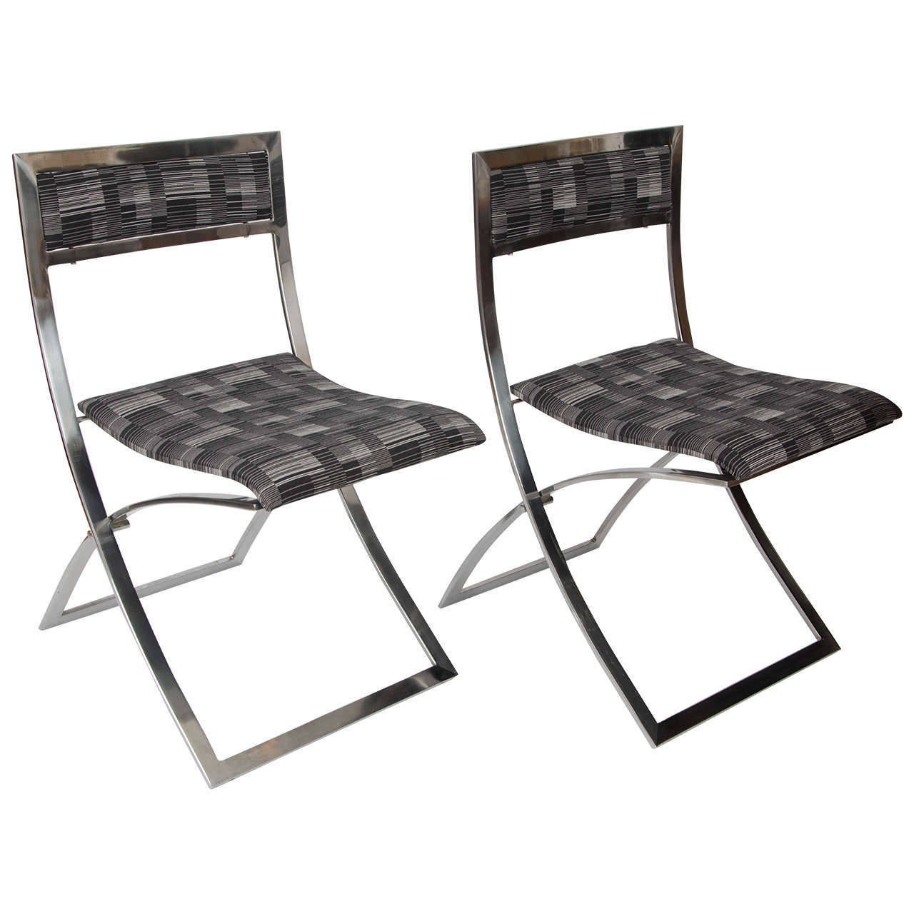 These 'Luisa' minimalist folding dining chairs are designed by the Italian architect Marcello Cuneo, 1970, for 'Mobel'. His designs were functional simple and elegant. 
The square shaped frames of the folding chairs are made from solid high quality