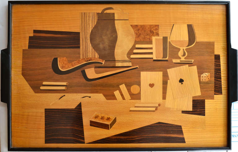 A unique tray crafted in a marquetry of exotic hard woods inviting us into a world of smoking, drinking, card and dice games in the 1940s and 1950s, surrounded by an ebonized frame.