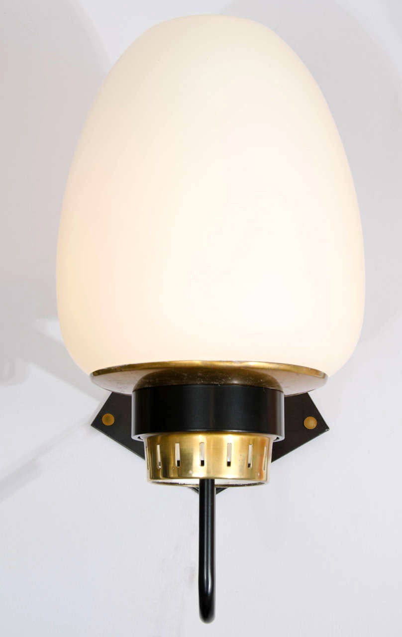 The opaline glass diffusers shades rest on a brass saucer shaped holders and black metal frame. The wall sconces can be used internally and externally.

There are three pairs available.
