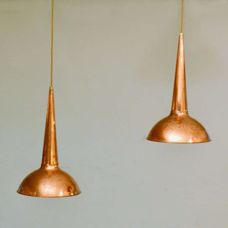 Two copper pendant lamps have oxidized through age giving the lamps its patina.
They can be individually hung at equal or different heights. Great over a kitchen isle or coffee table.