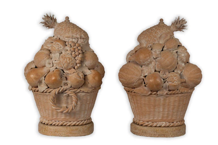 This large pair of sculptures is a virtuosic recreation of woven baskets containing renditions of exotic fruits and topped with pineapples.