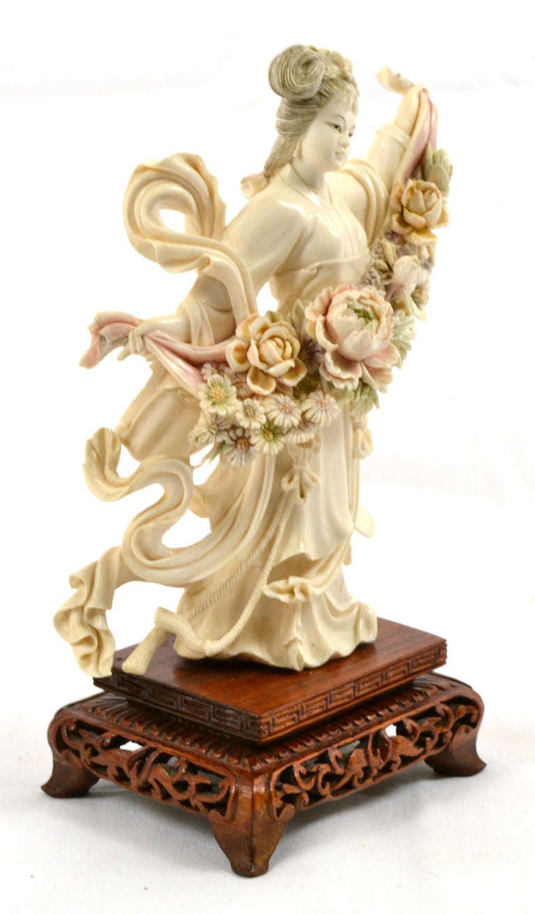 Figure en ivoire massif d'une Qinglou Nuzi chinoise (青楼女子) - l'équivalent chinois d'une geisha:: qui était très instruite en art:: musique:: littérature et danse. Ce personnage danse en tenant un bouquet élaboré de fleurs qui ont été teintées. La