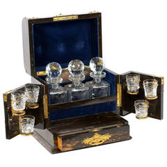 An English Black 
White Ebony Tantalus with Blue Velvet Interior