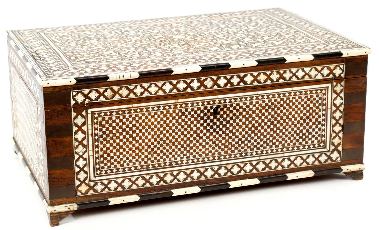 A very fine, ornate large jewelry box with inlaid bone exterior and interior. The lid opens up to reveal a mirrored interior with several compartments. The piece was made in Indochine during the third quarter of the nineteenth-century