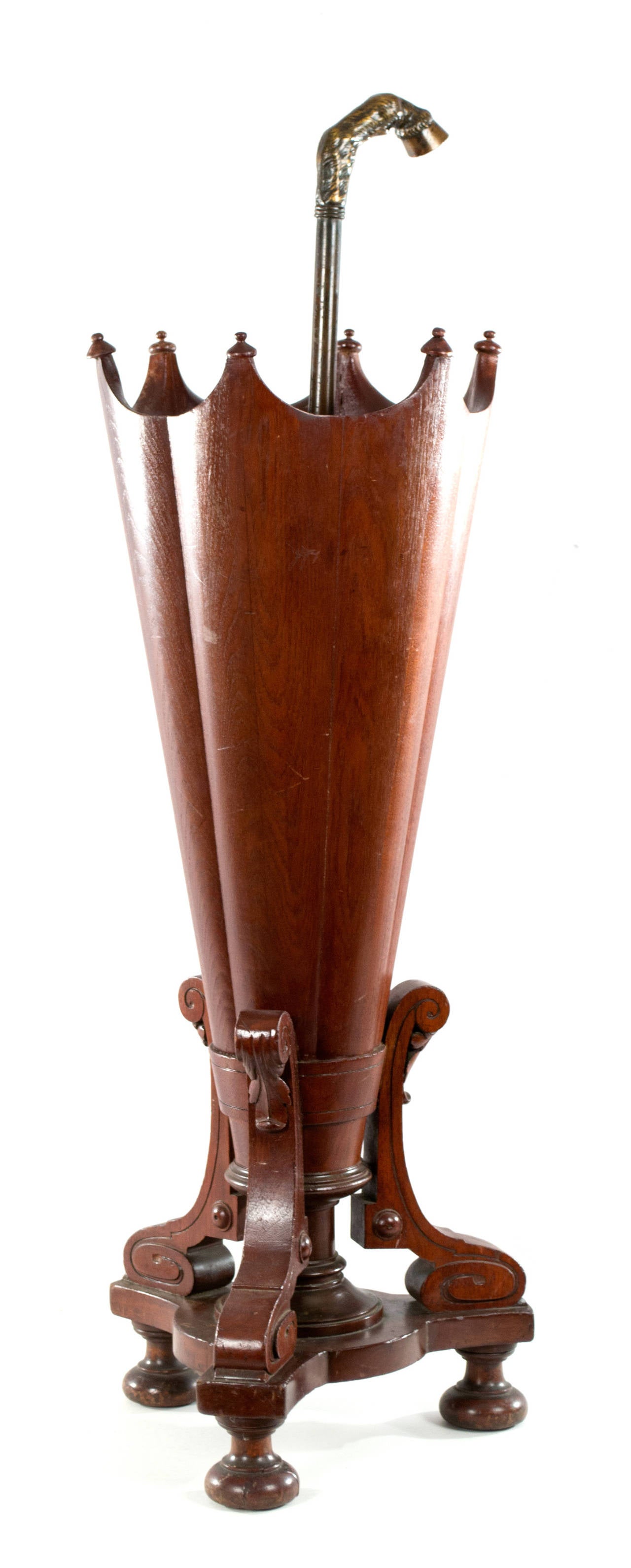 An American, turn-of-the-century, carved mahogany umbrella stand in the shape of an upturned umbrella. The handle of the umbrella is a beautifully sculpted bronze goat hoof.
