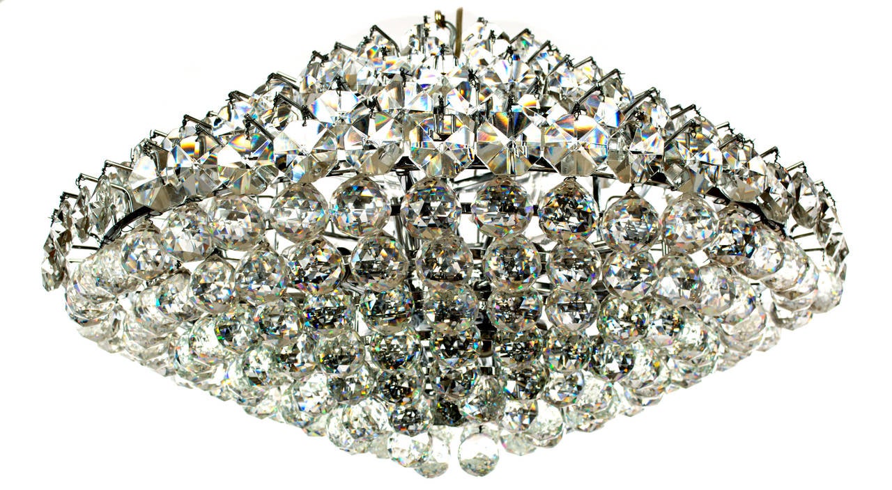 With eight lights and nearly 100 cut glass pieces — shaped as globes and discuses — the design of this large chandelier reflects mid-century Italian aesthetics.