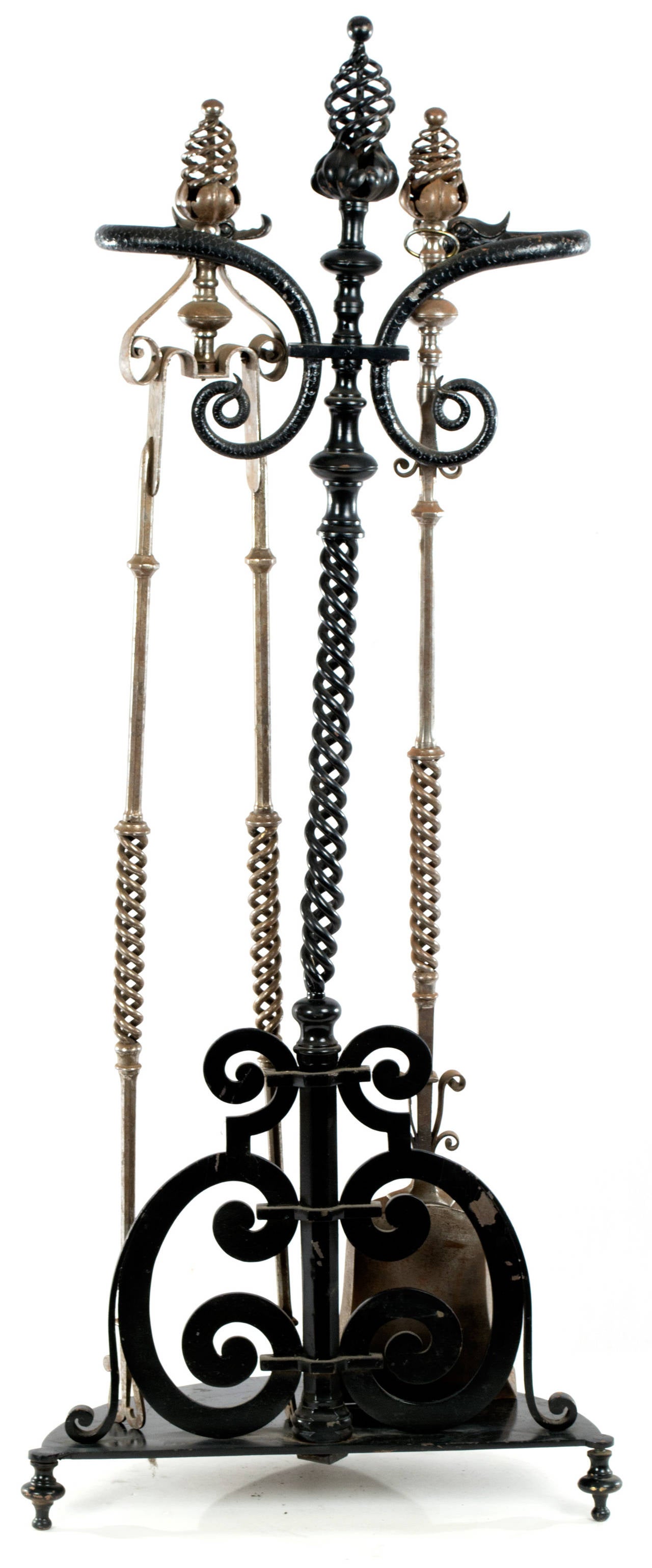 A beautifully turned and pierced set of fireplace tools (i.e. tongs, shovel) with stand featuring dolphin brackets; made in France during the last quarter of the nineteenth-century.