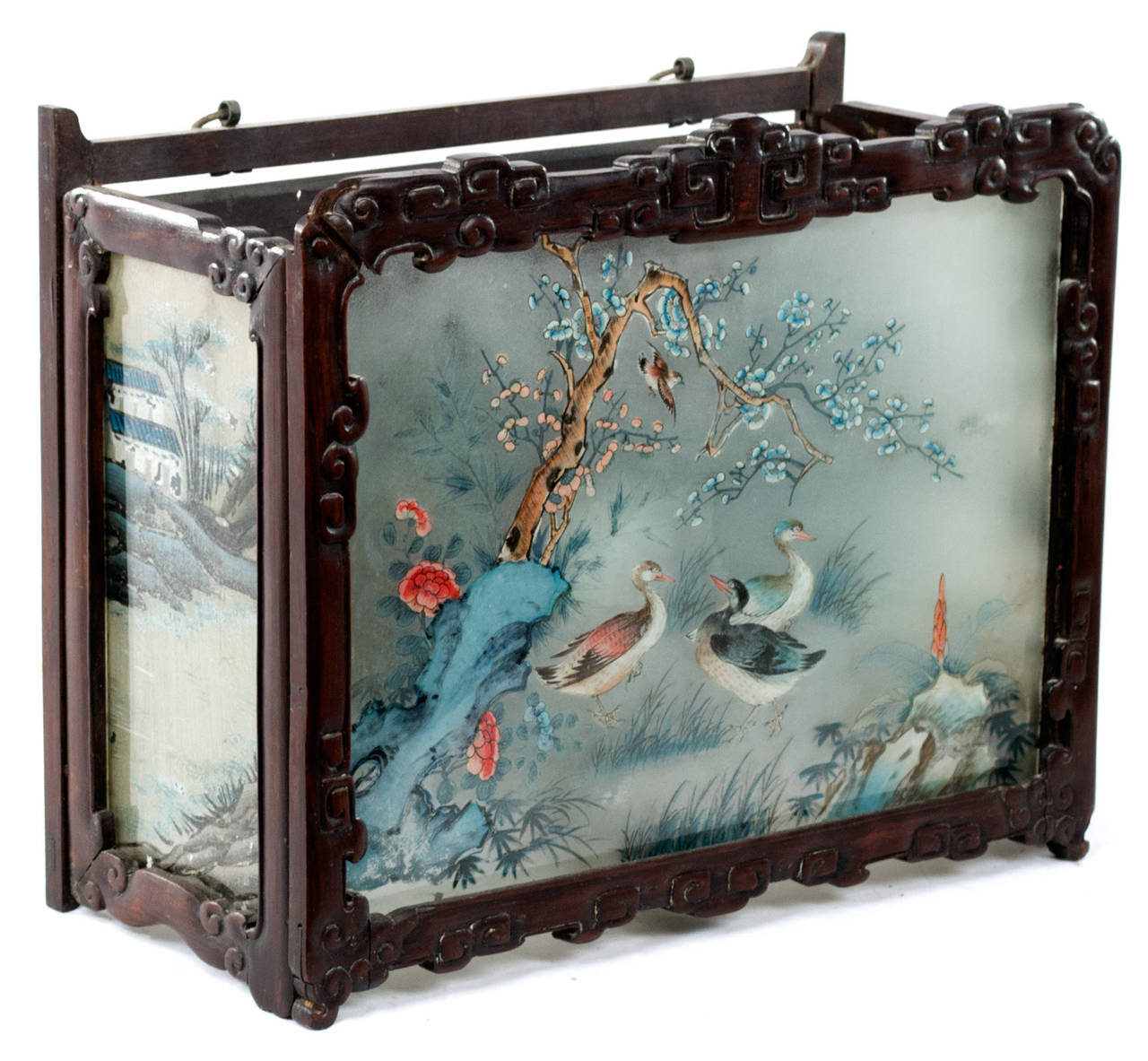 A mounted light encased by three beautifully painted panels of nature scenes in carved wood surrounds made in Japan.