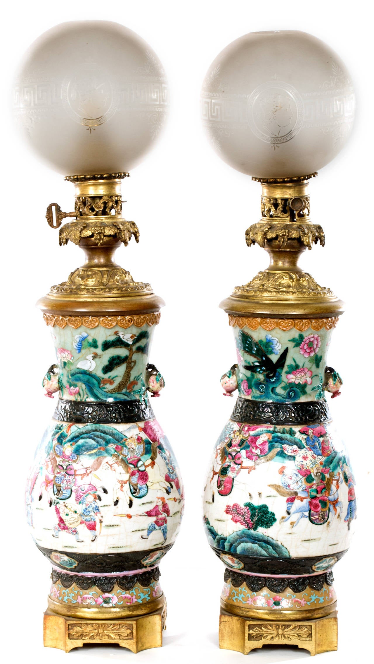 Two famille rose, white ground porcelain vases with polychromed figurative paintings of battle scenes. The vases have been lamped with working ormolu and brass fixtures wired for European sockets and fitted to ormolu bases.