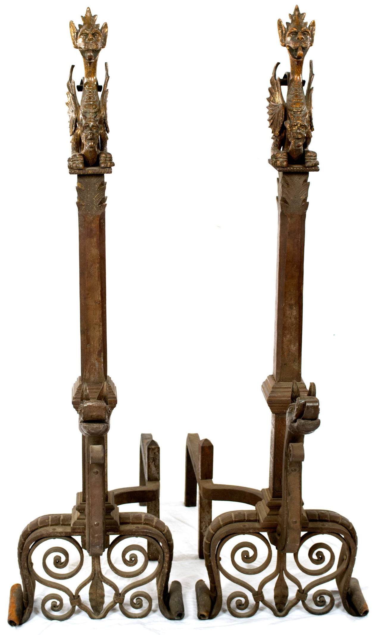 Two andirons inspired by the designs of the French architect Eugène Violet-le-Duc (1814 - 1879), who was responsible for the restoration of Notre Dame and an advocate for Gothic Revival. Featuring four dragons, two at the base in wrought iron, and