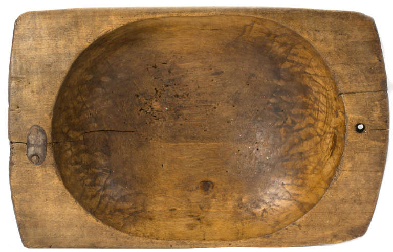 A hand carved walnut bowl from the last quarter of the nineteenth century